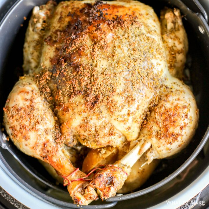 Image of a roasted chicken sitting in a pressure cooker, instant pot, or ninja foodi.