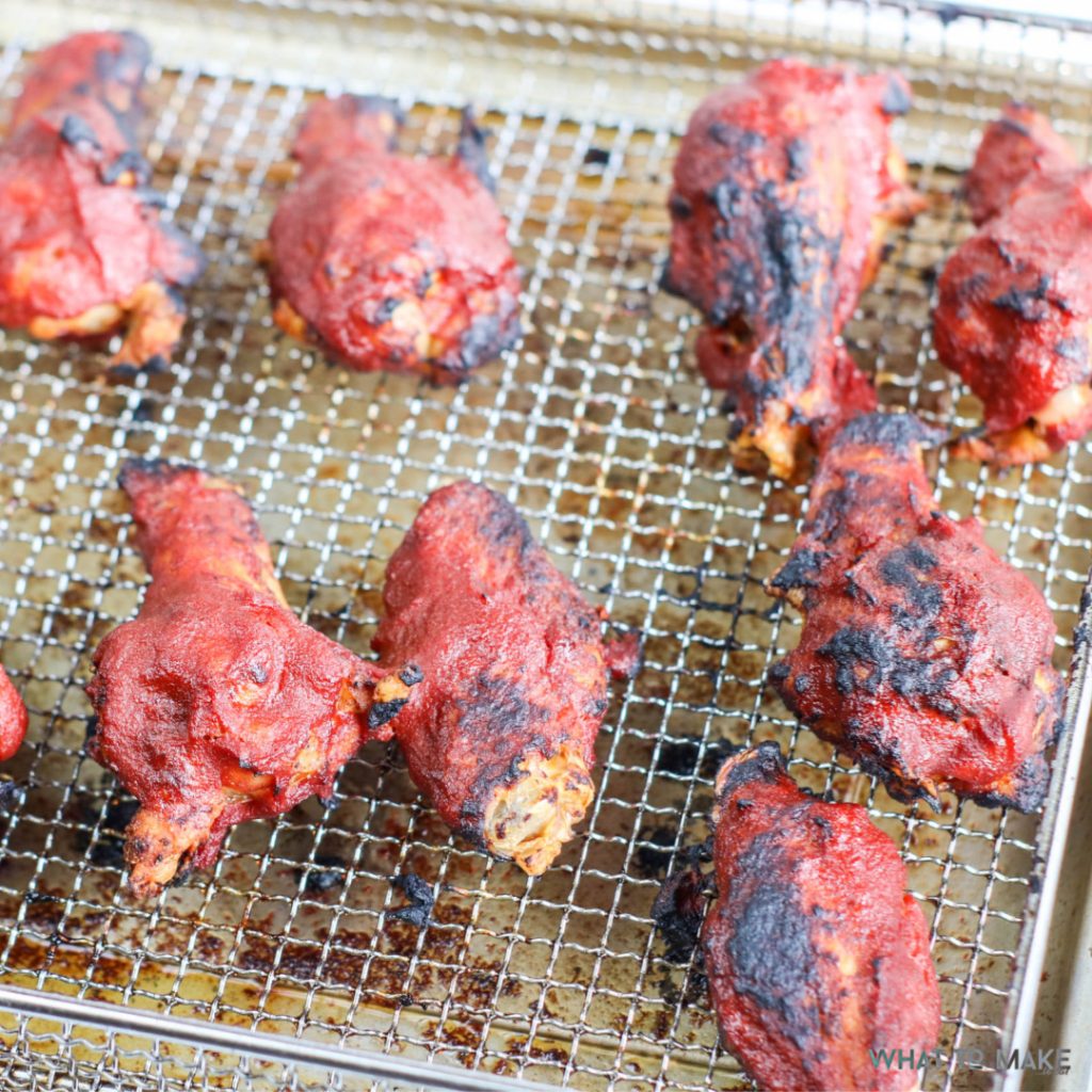 Image is an in process shot of air fryer bbq chicken wings.