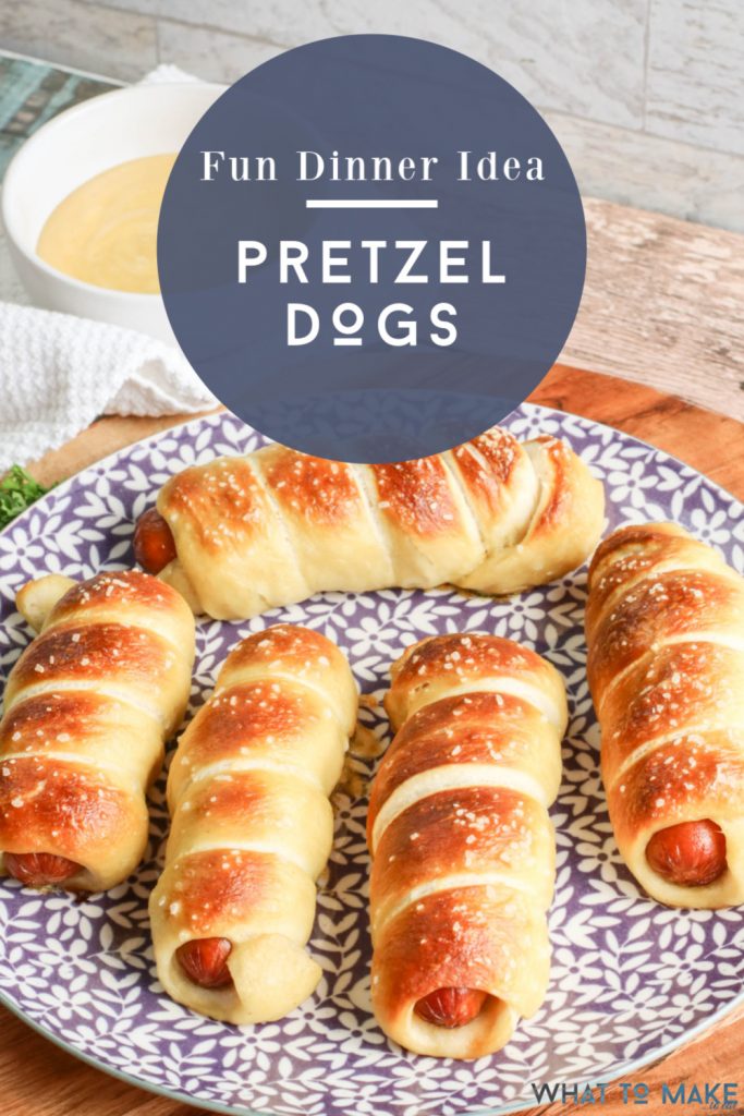 pretzel hot dogs on a plate. Text reads "Fun dinner idea - pretzel dogs"