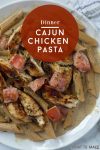 Image is of an easy cajun chicken pasta penne dish. Text reads "dinner Cajun chicken pasta"